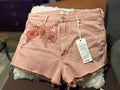 Front view of Wrangler dusty rose denim shorts with floral fabric paint detail