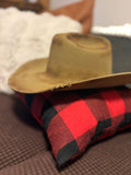 Tan felt cowboy hat — side profile view on buffalo plaid