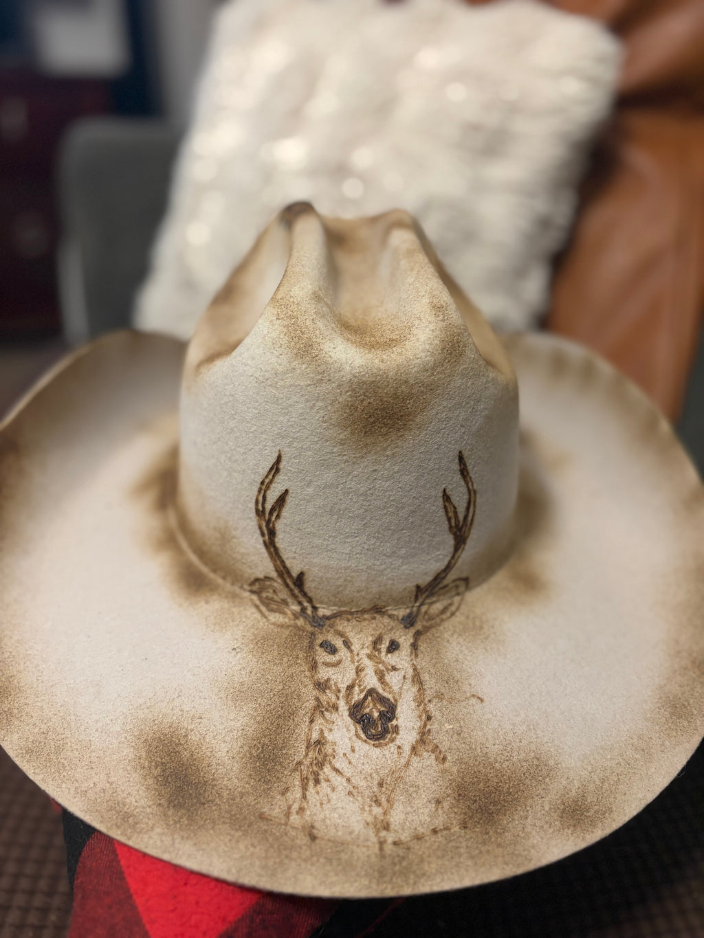 Close-up of hand-burned stag pyrography design on the crown