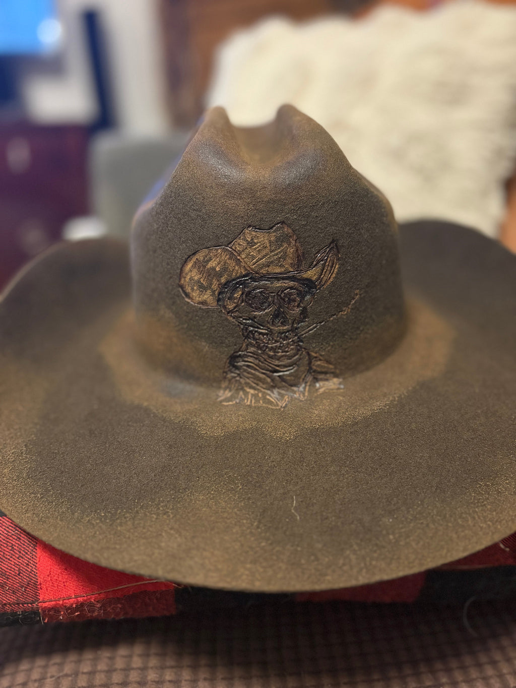 Dark olive felt cowboy hat with gold chain-stitch brim detailing, side view