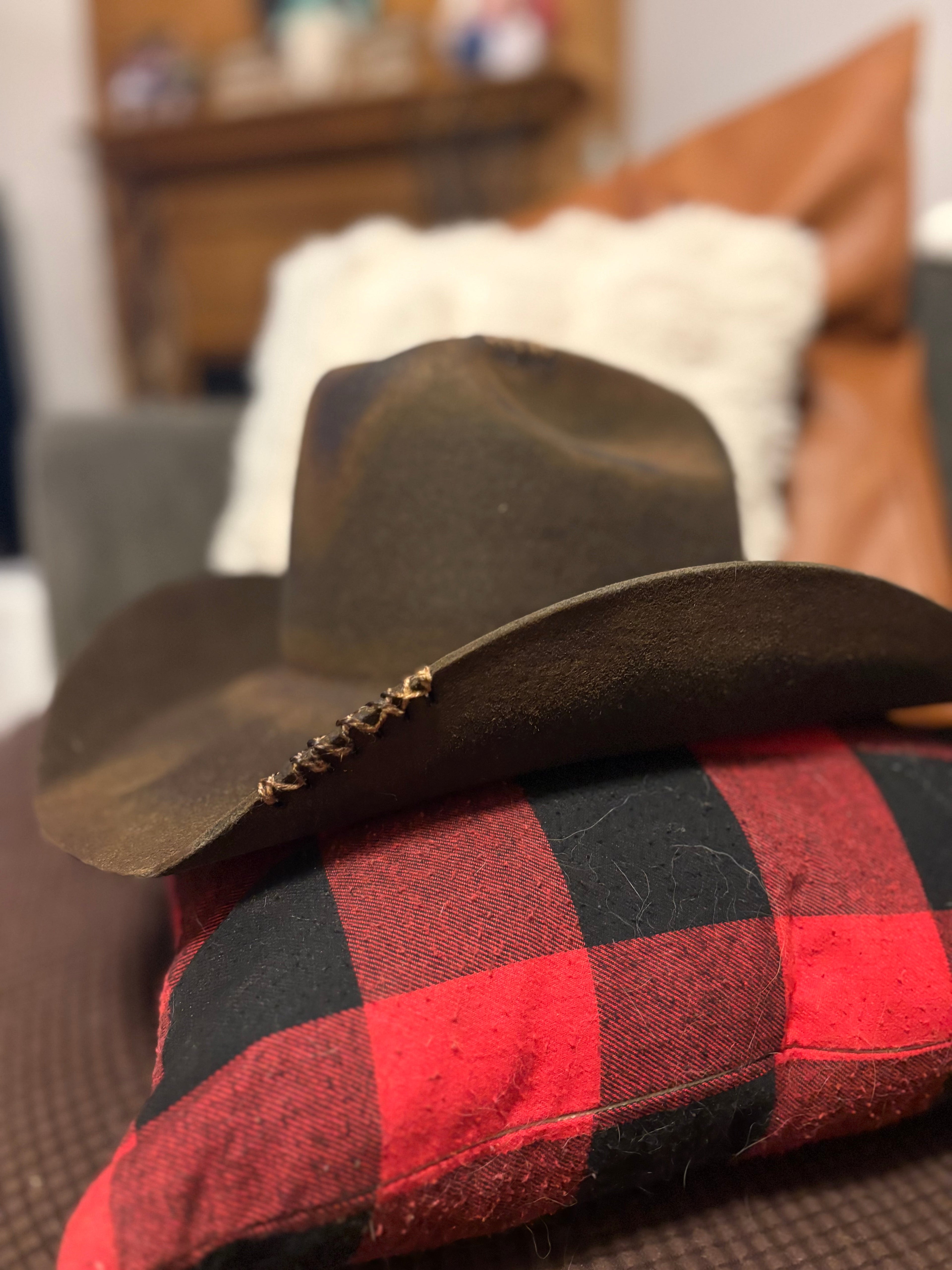 Dark olive felt cowboy hat with hand-burned pyrography cowboy skull wearing glasses and bandana, front view